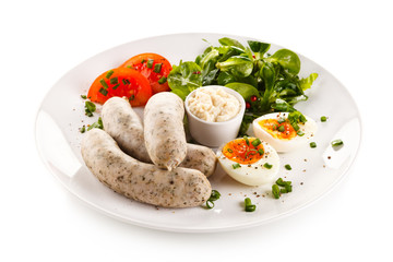 Easter breakfast - eggs, boiled white sausages and vegetables 