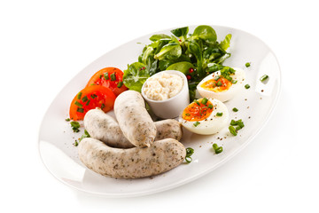 Easter breakfast - eggs, boiled white sausages and vegetables 