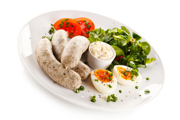 Easter breakfast - eggs, boiled white sausages and vegetables 