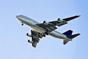 Fototapeta na wymiar flying airplane on blue sky background