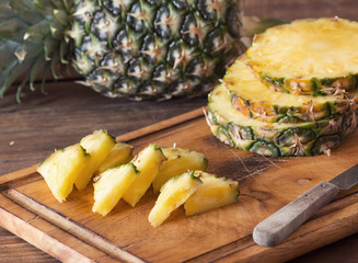 Pineapple fruit cut on wooden plate