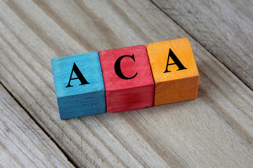 ACA (Affordable Care Act) acronym on colorful wooden cubes
