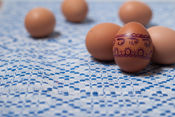 Colorful eggs on blue white towel