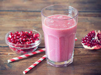 pomegranate smoothie on wooden background