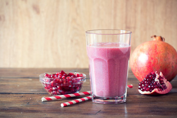 pomegranate smoothie on wooden background