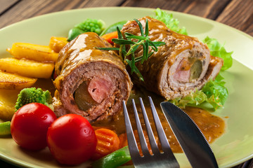 Pork rolls with prepared potatoes and vegetables