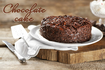 Tasty chocolate cake on wooden background