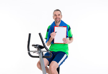 young man with clipboard train on fitness machine
