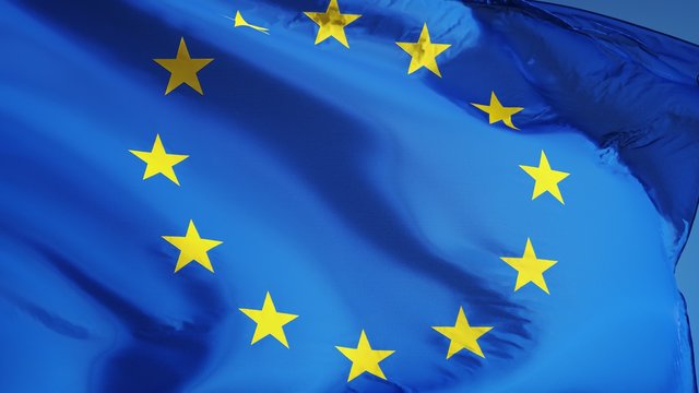 European Union flag waving in slow motion against blue sky, seamlessly looped, close up, isolated on alpha channel with black and white luminance matte, perfect for film, news, digital composition