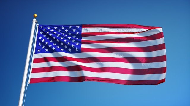 USA flag waving in slow motion against clean blue sky, seamlessly looped, close up, isolated on alpha channel with black and white luminance matte, perfect for film, news, digital composition