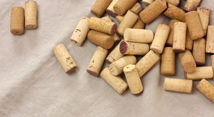 Heap of wine corks on grey cloth with copyspace