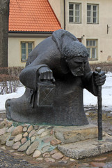 CESIS, LATVIA - MARCH 17, 2012: Monk statue that war installed on the place of the underground passage from the Cesis castle to the Saint John the Baptist Lutheran church
