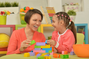 Fototapeta premium little girl playing with mother