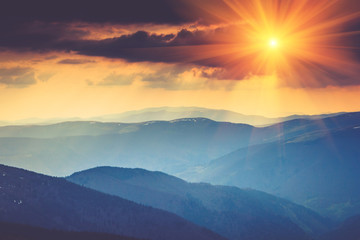Colorful sunset in the mountains landscape.Dramatic overcast sky.