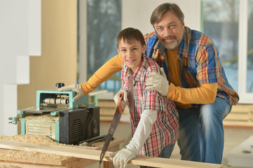 Fototapeta premium father and little boy repairing in the room