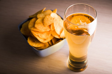 Beer in glass and potato chips
