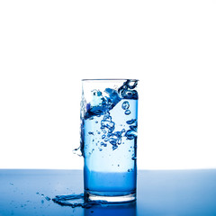 Pouring water into glass isolated