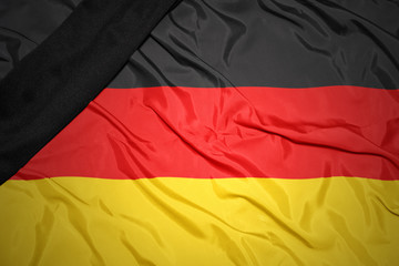 national flag of germany with black mourning ribbon