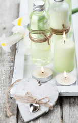 Fototapeta na wymiar Bath products, candles, wooden background