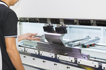operator bending metal sheet by sheet bending machine