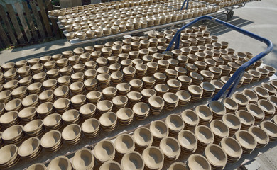 Ceramic cup in rack prepare for bring in furnace in factory