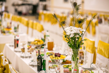 Elegant Wedding decorations with flowers and peacock feathers