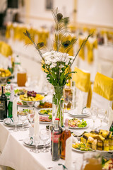 Elegant Wedding decorations with flowers and peacock feathers