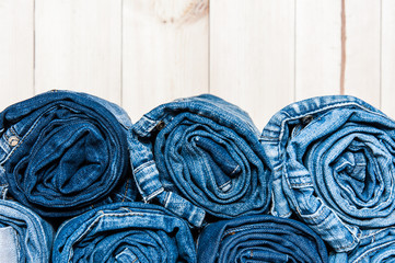Clothing. twisted jeans on a wooden background