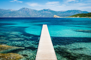 View of a pier in beautiful turquoise lagoon on Corsica island (France)