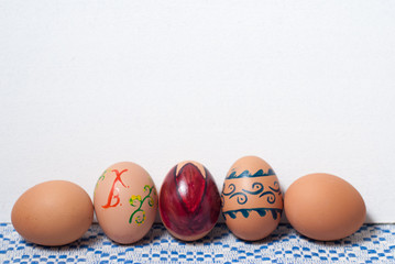 Colorful eggs on blue white towel