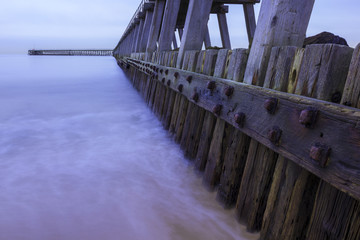 South Pier, Blyth, Northumberland, England, UK, on very dull overcast day, long exposure and split tone colour processing.
