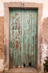 Close view of an old green wooden door.