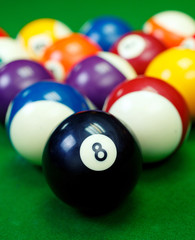 billiard balls on a green pool table, closeup