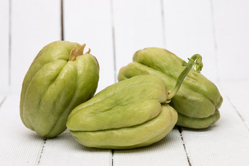 Chayote fruit on white wood background