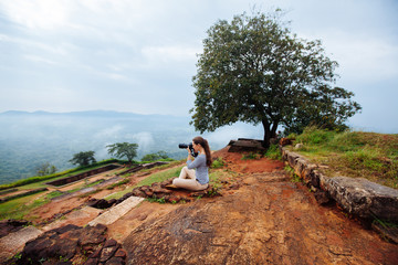 Fototapeta premium Nature photographer with digital camera on top of the mountain.