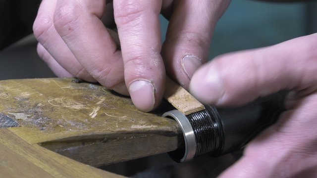 a craftsman repairing an old clarinet