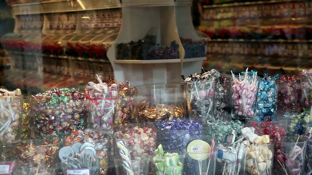 STOCKHOLM, SWEDEN: Candy store with reflection of crowd passing.