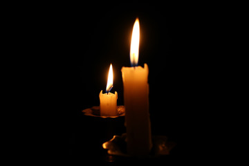 burning candle on a black background