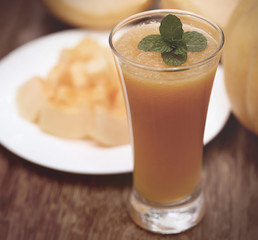 Muskmelon on a plate and juice
