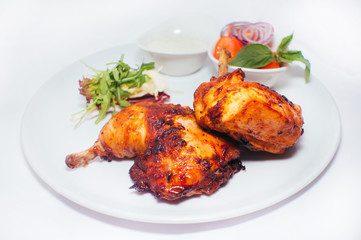 Fried chicken legs with salad from vegetables and greens with white sauce
