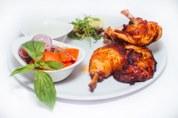 Fried chicken legs with salad from vegetables and greens with white sauce