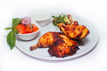 Fried chicken legs with salad from vegetables and greens with white sauce