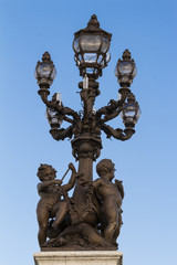 Fototapeta na wymiar The bronze lamp on Bridge Alexandre III