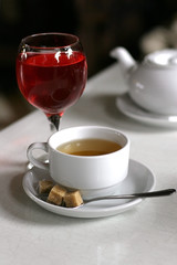 tea cup with glass of juce on the white table