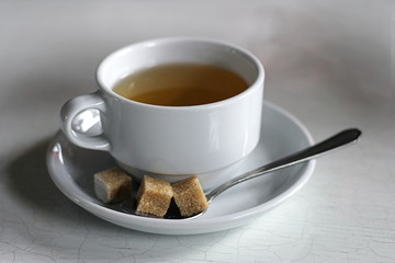 tea cup with brown sugar on a plate