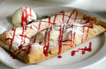 apple strudel with ice cream, focus in the middle