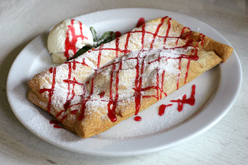 apple strudel with ice cream, focus in the middle
