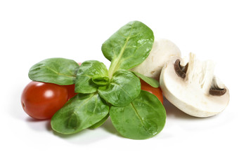fresh garden salad with white mushrooms, cherry tomatoes and corn salad, isolated on white background.