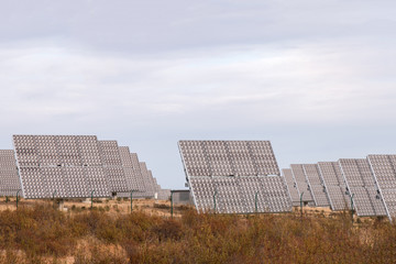 Field of photovoltaic solar panels gathering energy.