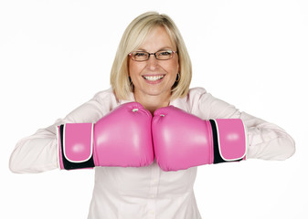 Blonde haired woman wearing pink boxing gloves on white background